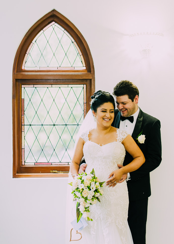 A bride and groom snuggling and talking