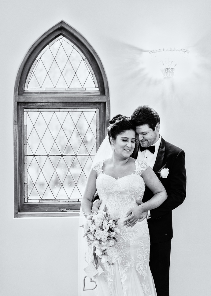 A bride and groom snuggling and talking