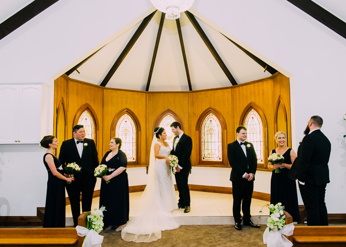 A wedding party standing in a chapel