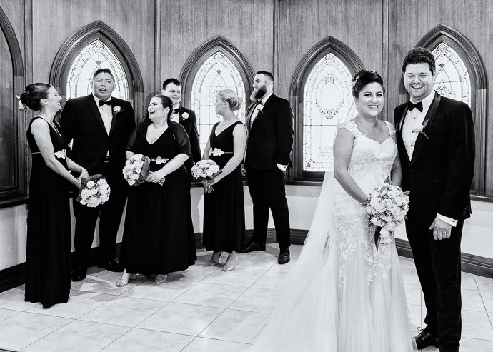 A wedding party standing in a chapel