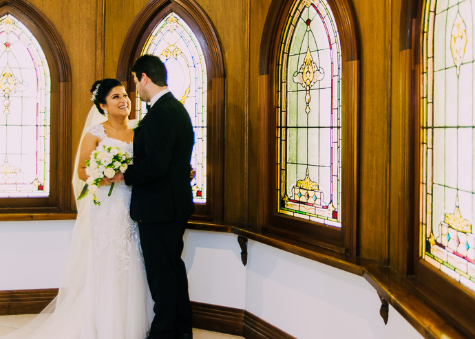 A bride and groom standing in a chapel