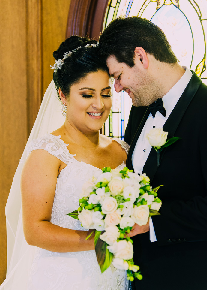 A bride and groom standing in a chapel