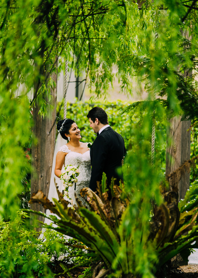 A bride and groom with trees around them