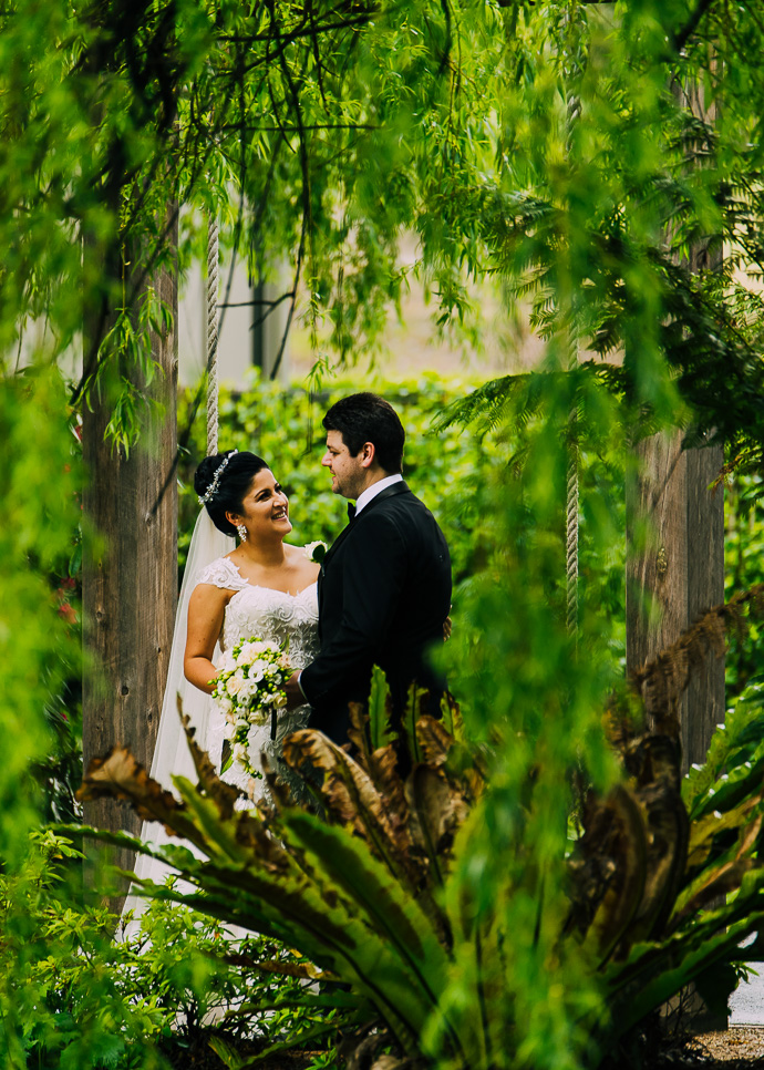 A bride and groom with trees around them