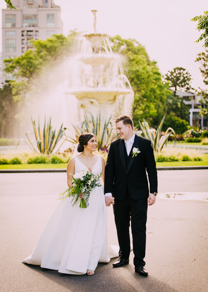A bride and groom taking wedding photos in Carlton Gardens