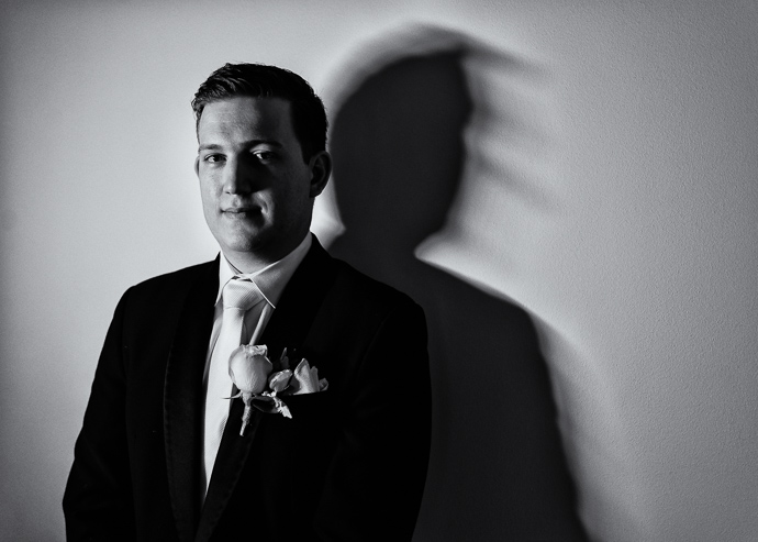 Groom and groomsmen getting ready for a wedding, black and white