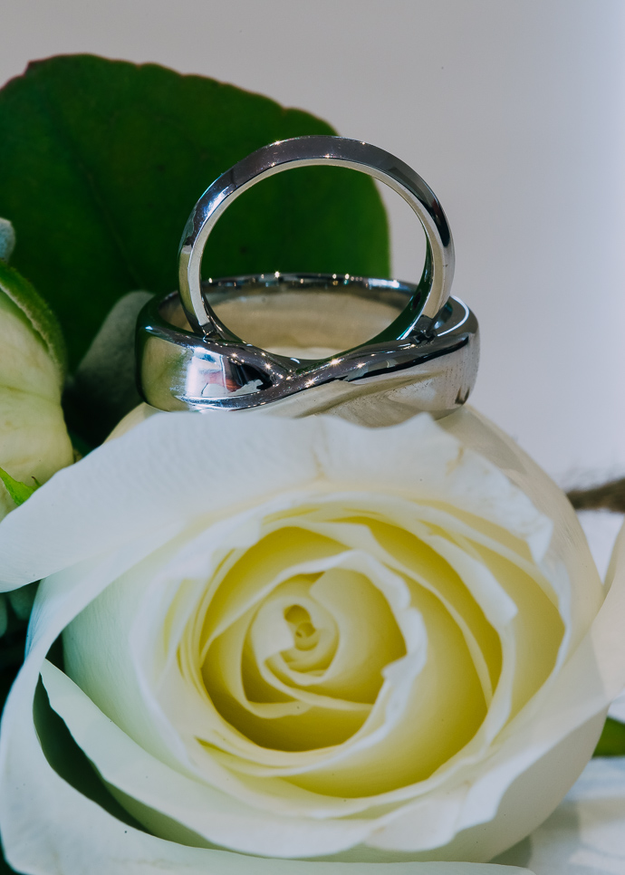 Wedding rings on a white flower
