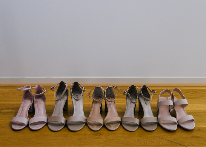 Bridal shoes lined up on a wooden floor