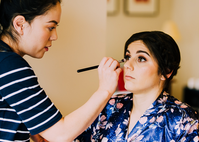 A bride having her makeup put on