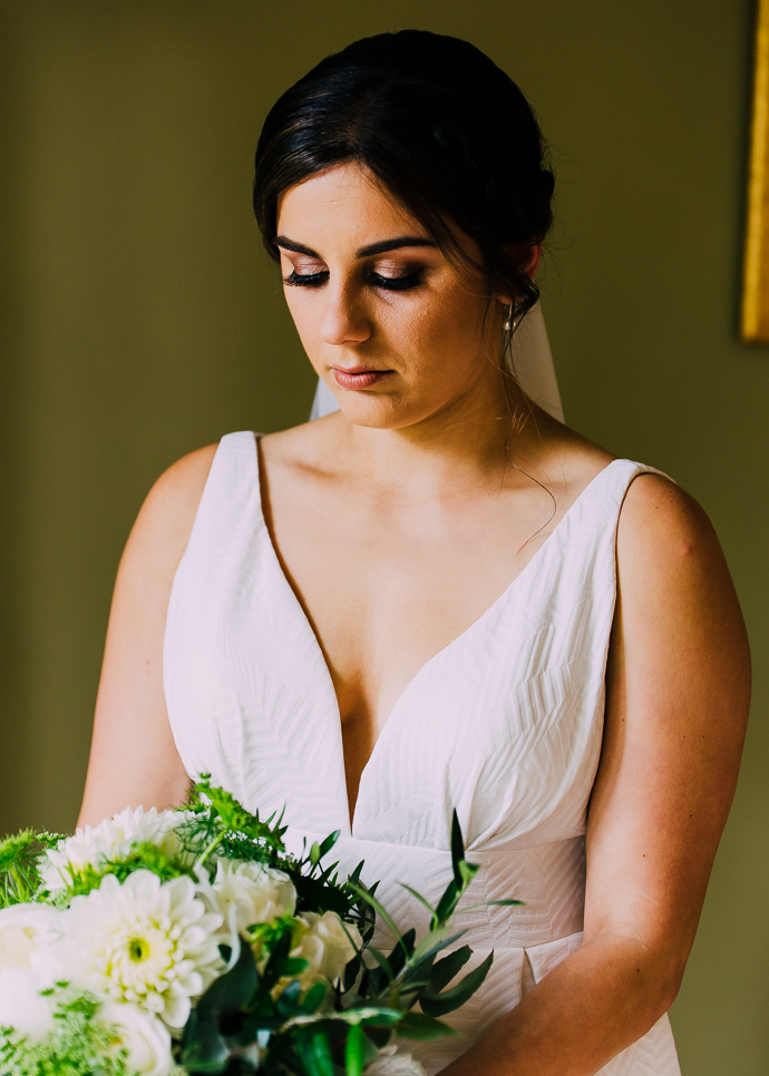 A bride in her wedding dress with flowers