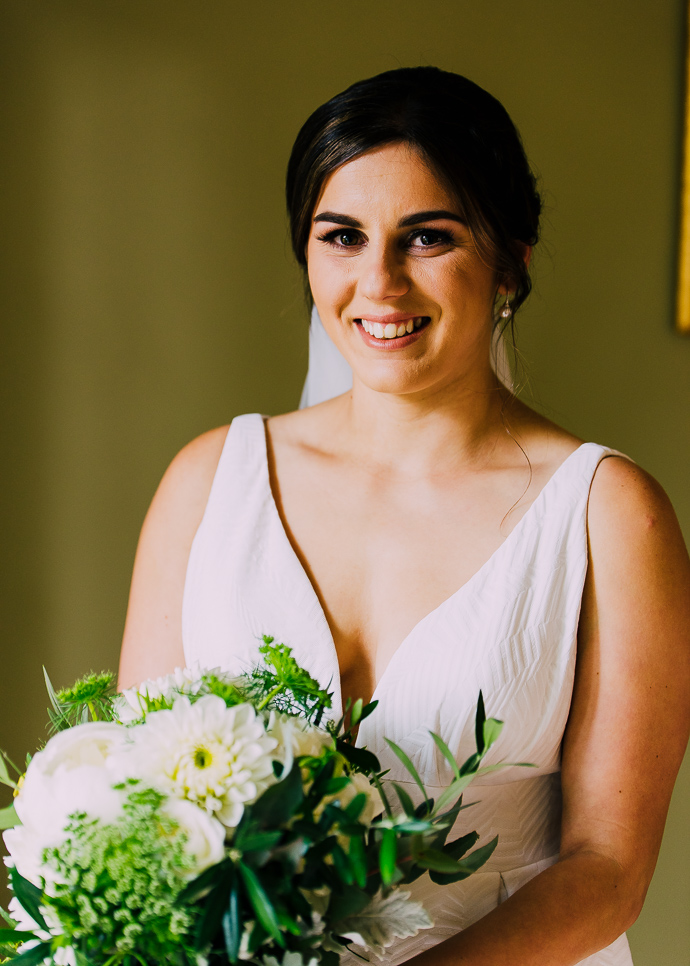 A bride in her wedding dress with flowers