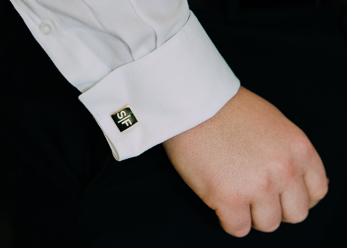 A hand in a shirt with cufflinks