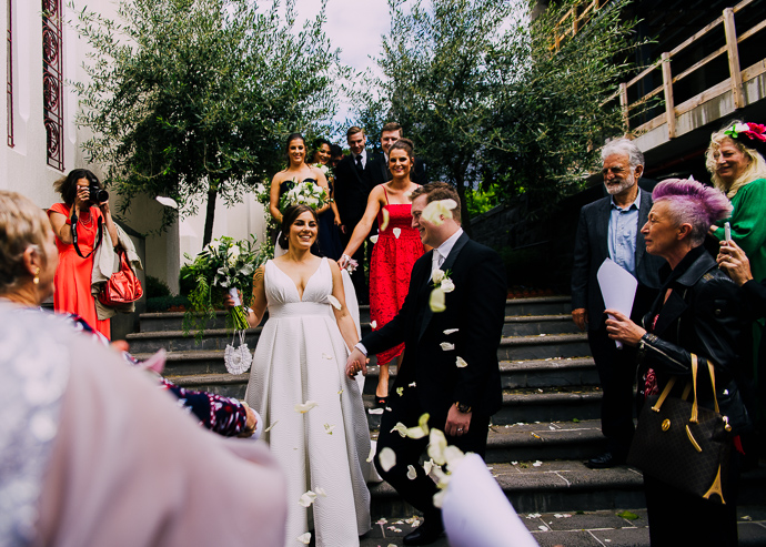 A bride and groom posing outside St Eustathios in South Melbourne