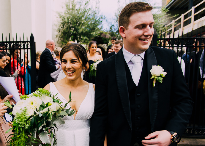 A bride and groom posing outside St Eustathios in South Melbourne