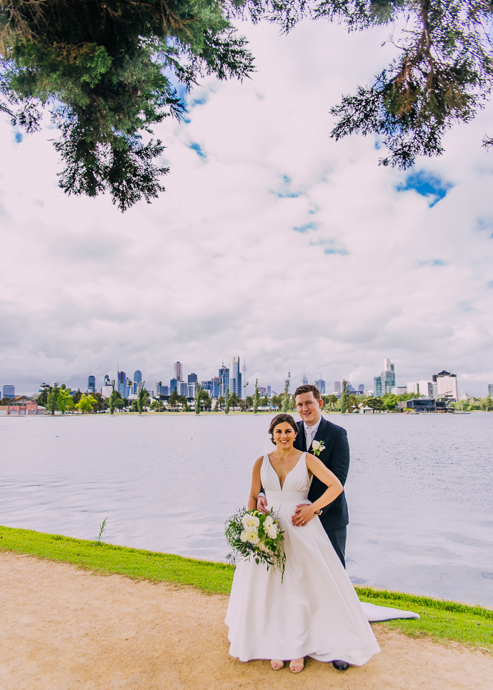 Two Ton Max wedding - A bride and groom walking next to Albert Park LAke, near Carousel in St Kilda